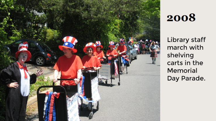 2008 Library staff march with shelving carts in the Memorial Day Parade. 